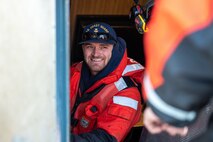 A photo of a man talking to another man.