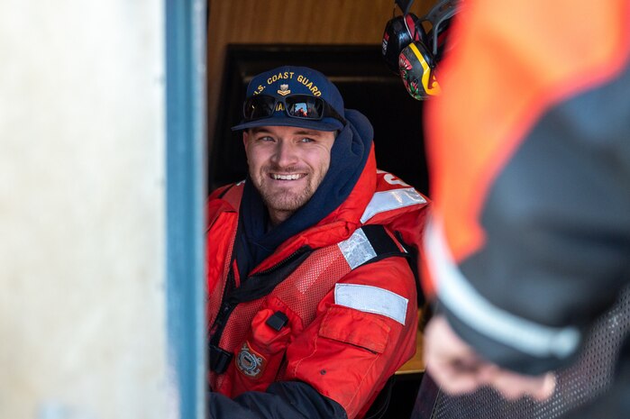 A photo of a man talking to another man.