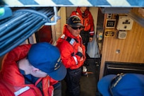 A photo of three men assessing a fire.