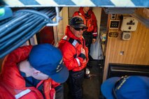 A photo of three men assessing a fire.