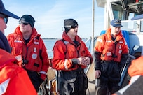 A photo of a man speaking to a crew.