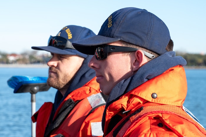 A photo of two men listening to a brief.