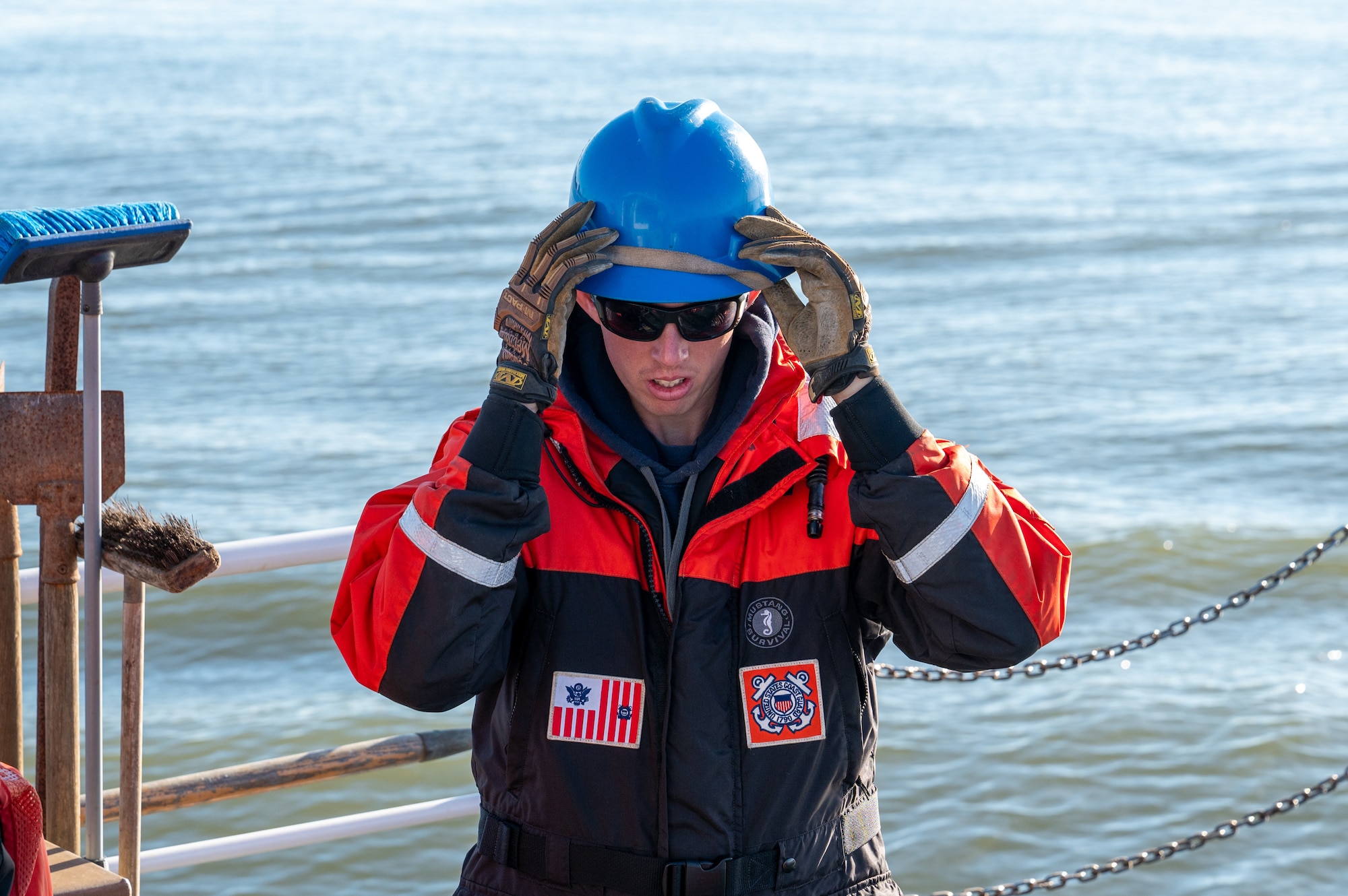 A photo of a man putting on a helmet.