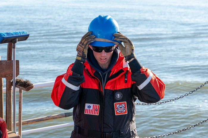 A photo of a man putting on a helmet.