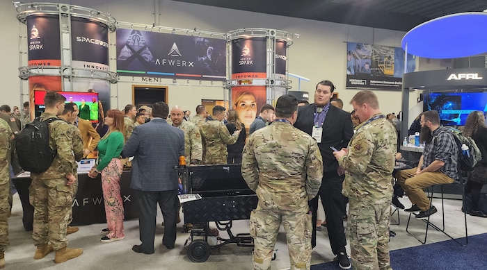 Airmen, Guardians and industry leaders visit the AFWERX booth to learn more about the organization during the Air and Space Forces Association’s Warfare Symposium in Aurora, Colorado, Feb. 14, 2024.