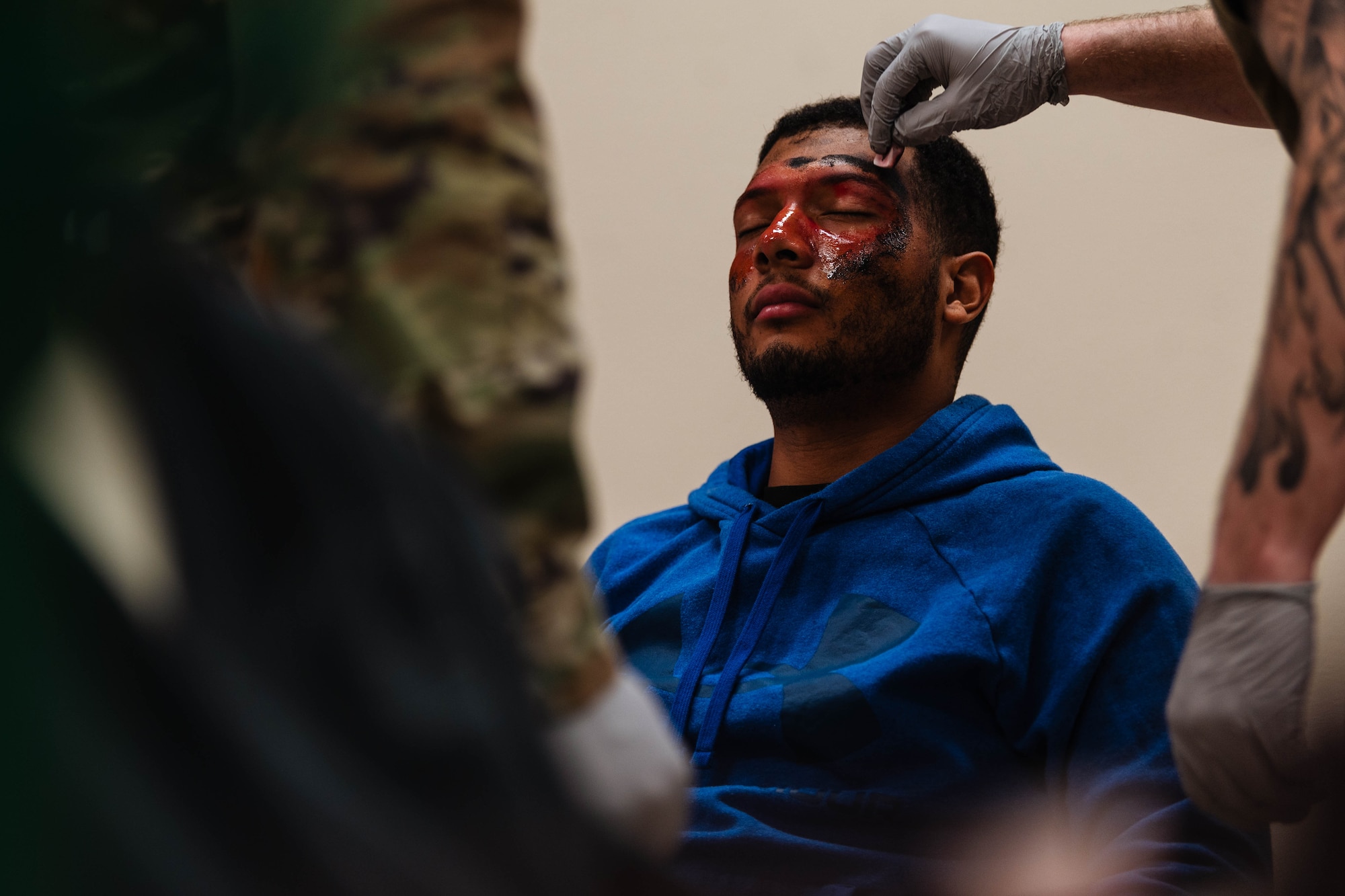 Members of the 56th Medical Group apply paint to U.S. Air Force Airman Medina Vargas, 56th Equipment Maintenance Squadron aerospace ground equipment technician, in preparation for exercise Ready Eagle II.