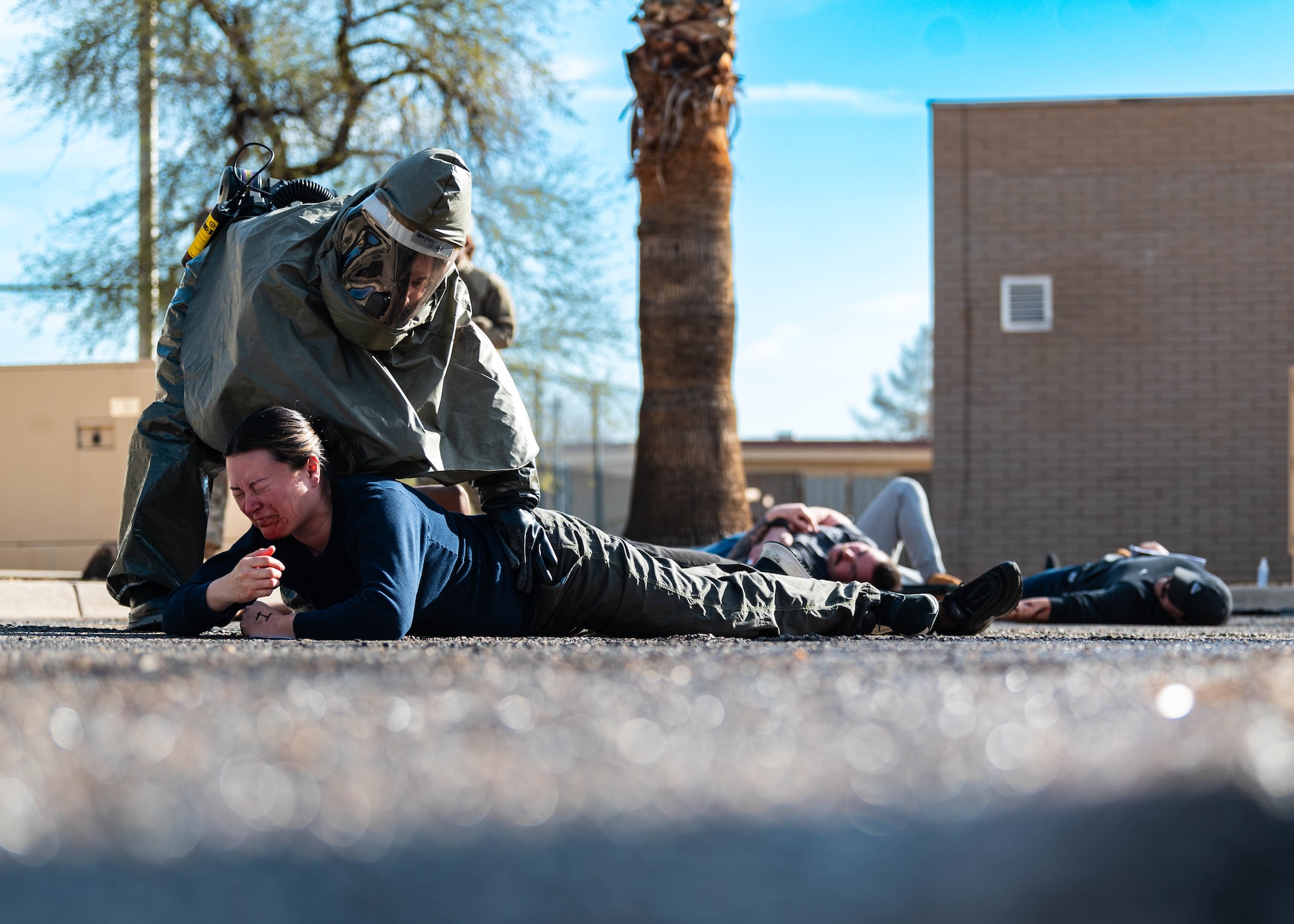 A U.S. Air Force Airman from the 56th Medical Group (top left) triages moulage patients during exercise Ready Eagle II.