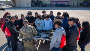 Students from Arthur Hamilton Junior High School visit a table hosted by the 56th Security Forces Squadron during the Black History Month School Immersion, Feb. 15, 2024, at Luke Air Force Base, Arizona.