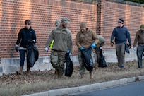 Volunteers from across Joint Base Anacostia-Bolling pick up trash at a base perimeter cleanup, JBAB, Washington, D.C., Feb. 6, 2024. JBAB officially took responsibility for the area through Adopt-A-Block, committing to keeping Overlook Avenue Southwest, from JBAB’s Arnold Gate to the U.S. Naval Research Laboratory’s main gate, clean for the community. (U.S. Air Force photo by Kristen Wong)