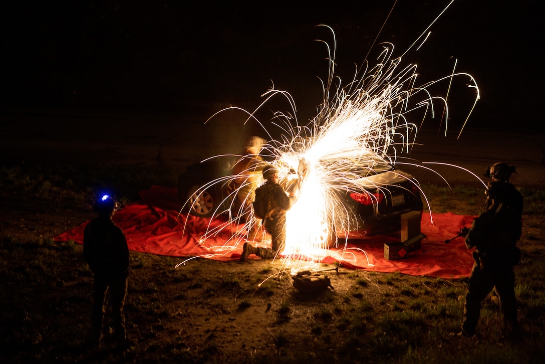 U.S. Marine Corps aircraft rescue and firefighting specialists with Marine Medium Tiltrotor Squadron 268, Marine Aircraft Group 24, 1st Marine Aircraft Wing, use a K-12 saw to cut open a simulated downed aircraft during a tactical recovery of aircraft and personnel course hosted by Expeditionary Operations Training Group, I Marine Expeditionary Force, at Marine Corps Base Camp Pendleton, California, Feb. 7, 2024. The TRAP course is designed to develop the capabilities of Marines to recover aircraft, personnel and equipment in austere environments. EOTG is a section of the I MEF command element that trains and evaluates deploying Marine Expeditionary Units, and other designated forces, in select individual and collective tasks to prepare them to support geographic combatant commands. (U.S. Marine Corps photo by Cpl. Barton)