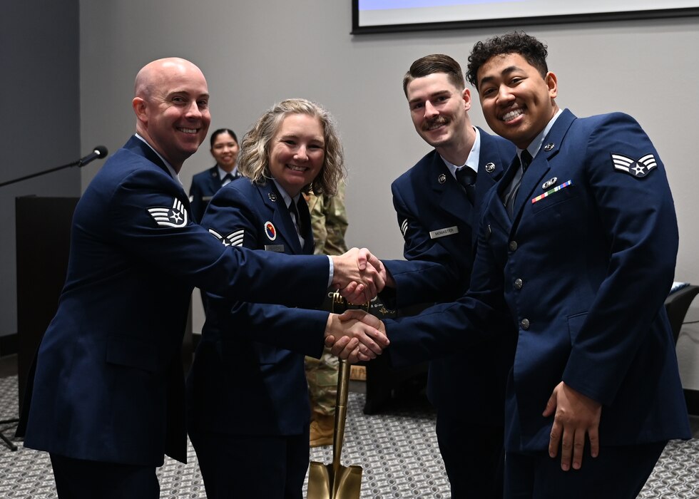 Airman Leadership School instructors are presented a class gift by students from ALS Class 24-B at the Powell Event Center, Goodfellow Air Force Base, Texas, Feb. 15, 2024. Traditionally, students present a gift to the instructors for use in the classroom or as a souvenir for their time spent with the instructors; the golden shovel represented an inside joke between students and instructors. (U.S. Air Force photo by Senior Airman Ethan Sherwood)