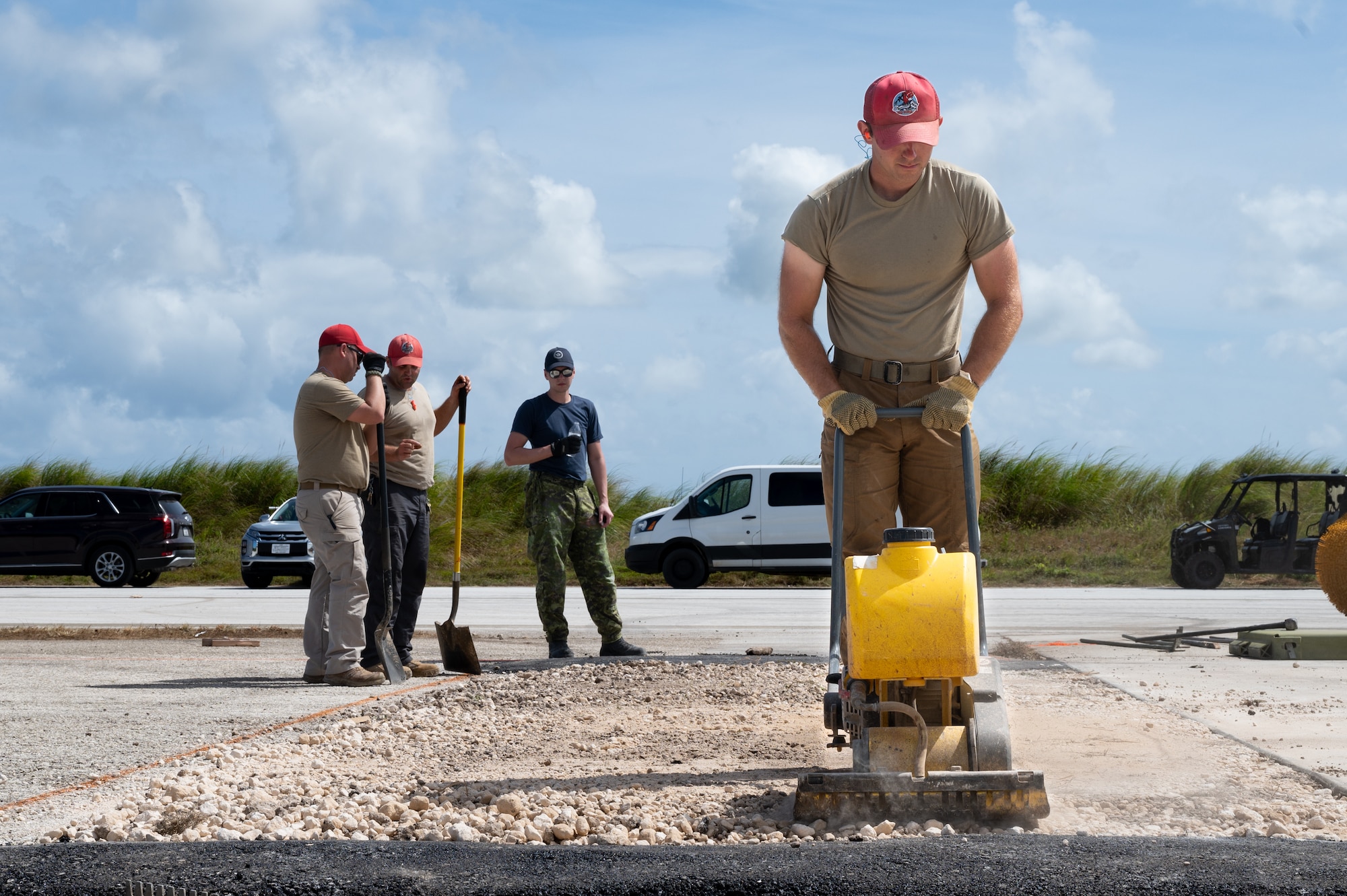 Civil engineers compact soil with a plate tamper.