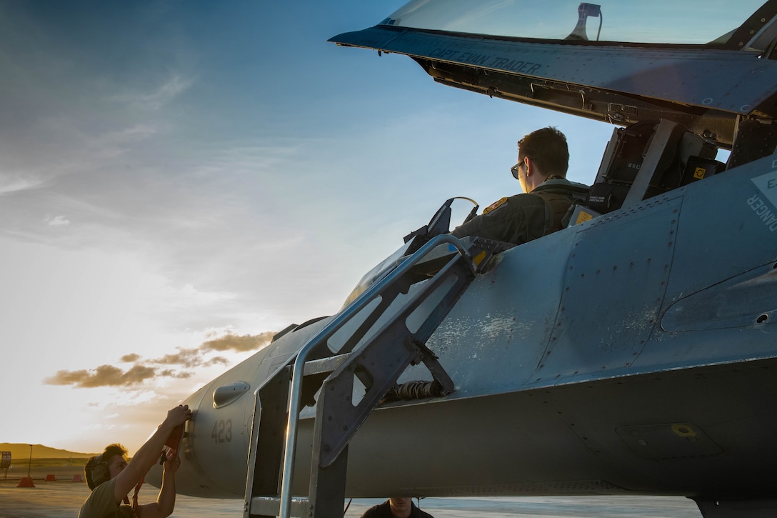 U.S. Air Force Maj. Daniel Simpson, 14th Fighter Squadron pilot, prepares to exit an F-16 Viper