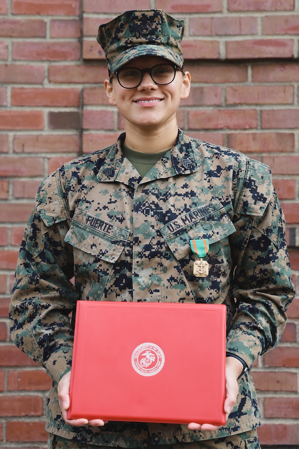 U.S. Marine Corps Sgt. Lina Fuerte, a legal services specialist with the Defense Services Organization, Headquarters and Support Battalion, Marine Corps Installations East-Marine Corps Base (MCB) Camp Lejeune, poses for a photo with her Navy and Marine Corps Achievement Medal (NAM) award citation on MCB Camp Lejeune, North Carolina, Feb. 16, 2024. Fuerte was recognized as the Marine Corps Installations Command’s Noncommissioned Officer of the Year for 2023 and was awarded a NAM for her efforts. (U.S. Marine Corps photo by Cpl. Zeta Johnson)