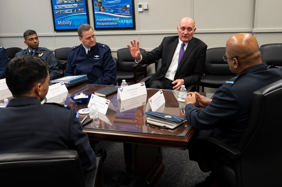Image of men sitting around table for business meeting.