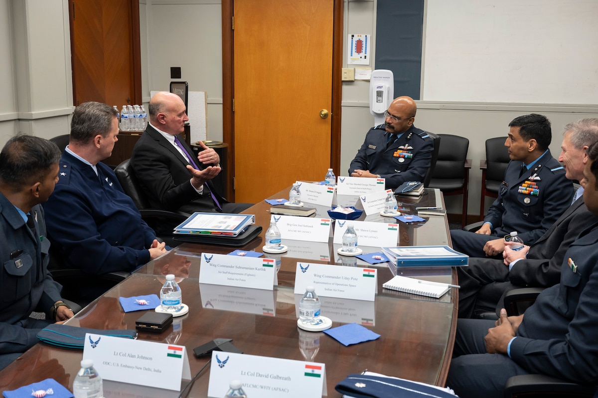 Image of men sitting around table for business meeting.