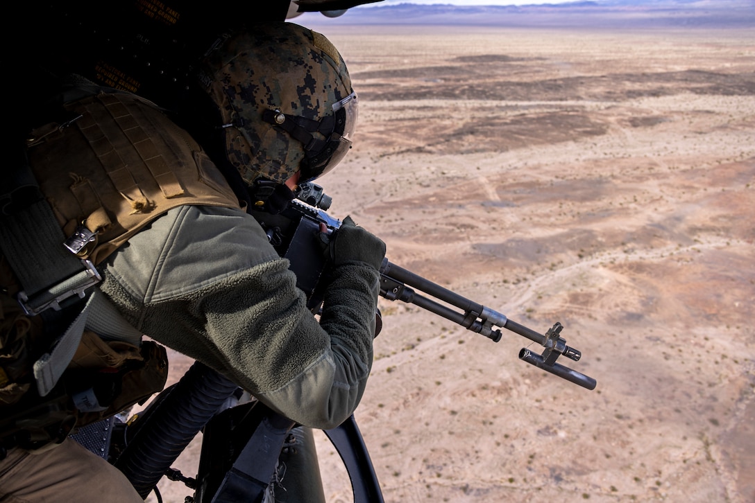 U.S. Marine Corps Cpl. Nicky Drury, a UH-1Y Venom crew chief with Marine Light Attack Helicopter Squadron (HMLA) 267, Marine Aircraft Group 39, 3rd Marine Aircraft Wing, shoots a M240D machine gun during Integrated Training Exercise 2-24