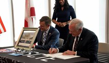 Richard De Fatta (right), deputy to the commanding general, U.S. Army Space and Missile Defense Command, and Matt Massey, president of the Alabama School of Cyber Technology and Engineering, sign an education partnership agreement at the school on Feb. 15, 2024, in Huntsville, Alabama. (U.S. Army photo by Ayumi Davis)