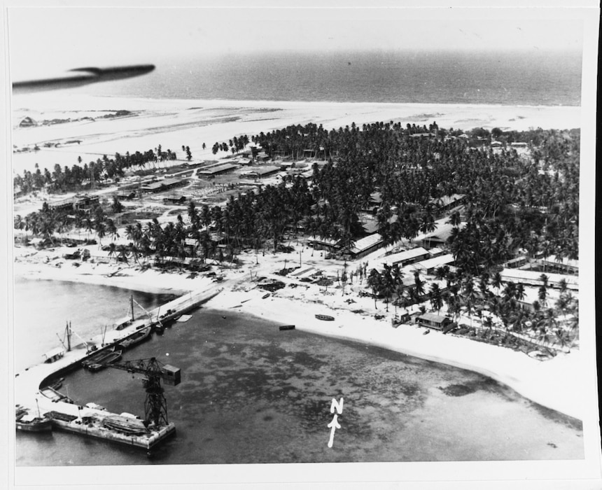 Namur Island, Kwajalein Atoll, photographed from a U.S. aircraft on 30 January 1944, before it was wrecked by pre-invasion bombardment. Note the many buildings and the pier (with a "hammerhead" crane) of the Japanese base there. Roi Island is in the far upper left. Virtually everything seen here was destroyed in the next few days. Naval History and Heritage Command Photo.