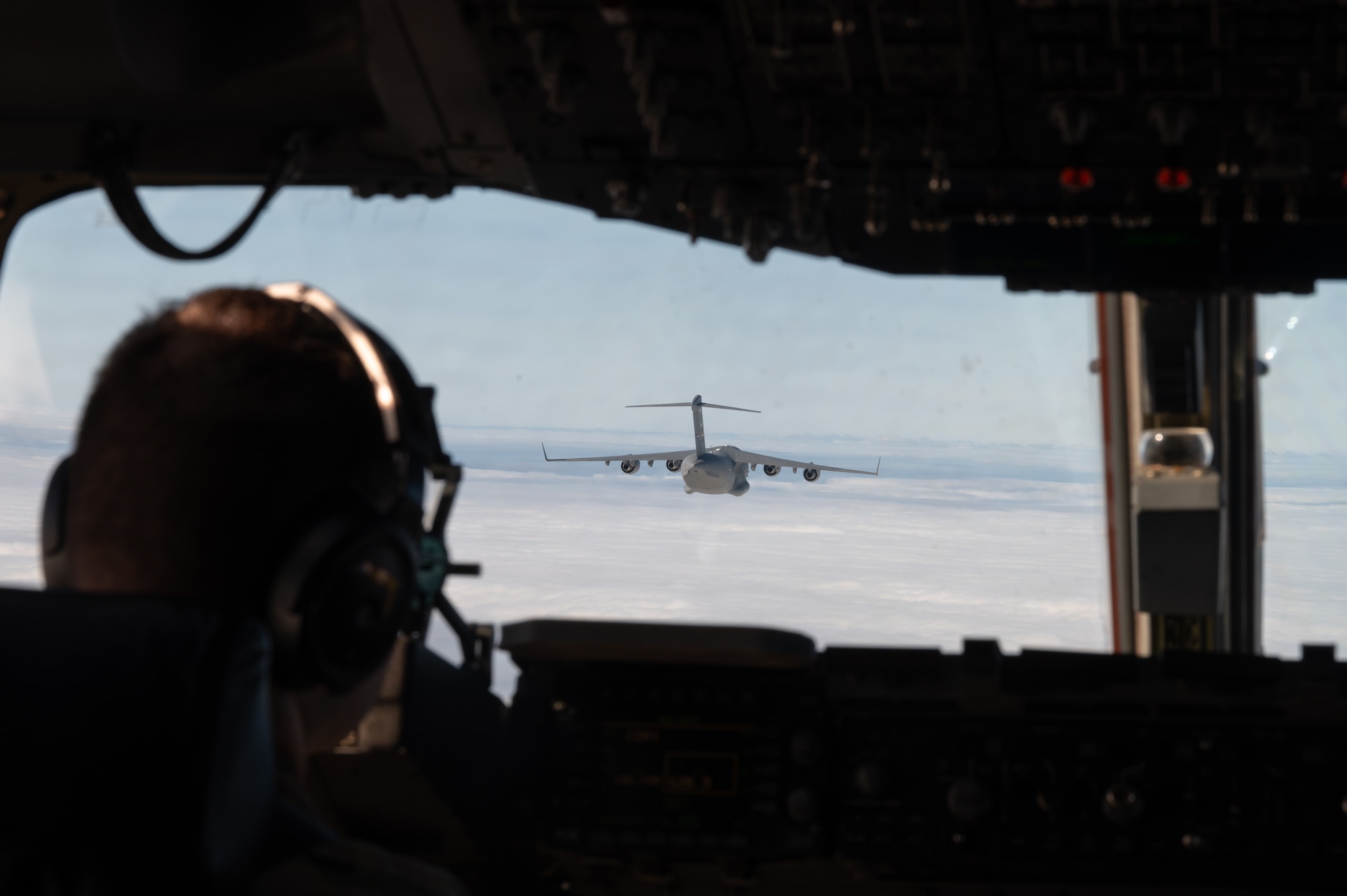 Two C-17 Globemaster IIIs’ trade leading and following positions within their flight path during the Tactics Advancement Course at Joint Base McGuire-Dix-Lakehurst, N.J., Feb. 7, 2024. Airmen assigned to the 6th Airlift Squadron loaded cargo onto the C-17 in order to provide support for the F-22 Raptors at Joint Base Langley-Eustis, Va. The advancements course postures Air Mobility Command Airmen to execute agile operations on a global scale. (U.S. Air Force photo by Airman 1st Class Aidan Thompson)
