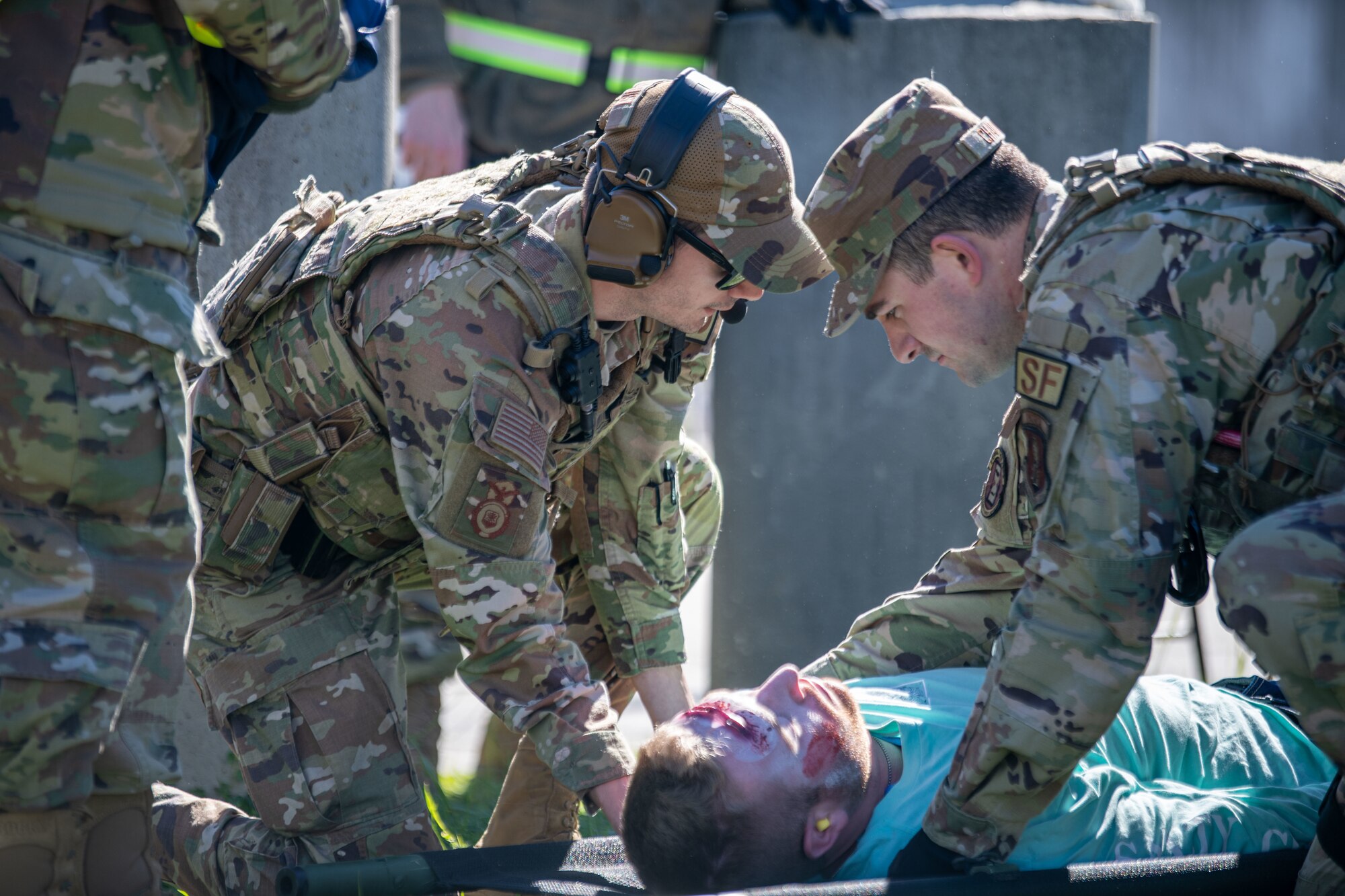 Airmen place an injured role-play victim on a gurney from aeromedical evacuation via helicopter during a PATRIOT 24 search and rescue exercise, Camp Shelby, Mississippi, Feb. 19, 2024.