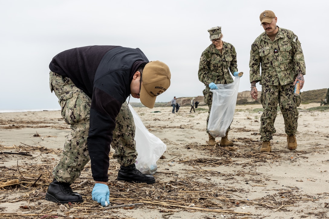 U.S. Navy sailors with Assault Craft Unit 5, collect trash during a beach cleanup at White Beach at Marine Corps Base Camp Pendleton, California, Feb. 16, 2024. This cleanup allows MCB Camp Pendleton and its tenant units to conduct preservation efforts while harmonizing environmental efficacy and military readiness. MCB Camp Pendleton takes active steps to preserve regional wildlife and natural resources while providing the Fleet Marine Force with the training spaces necessary to meet training and readiness requirements. (U.S. Marine Corps photo by Lance Cpl.  Watts)