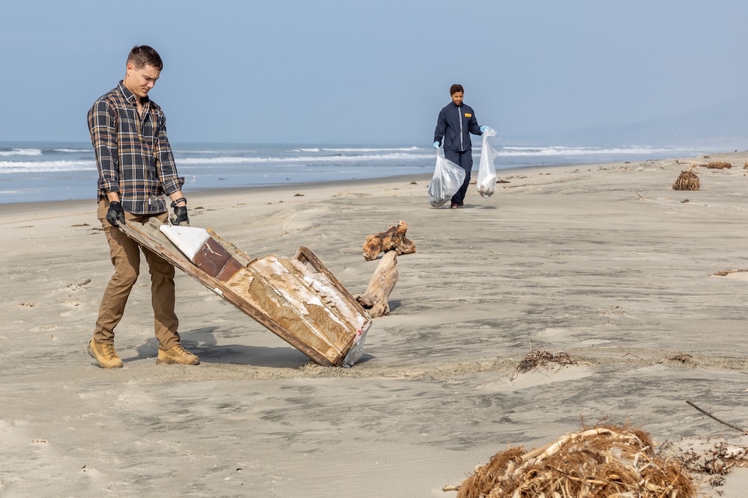 Chase Conrad, the hazardous waste chief with Marine Corps Base Camp Pendleton Environmental Security Department, collects a piece of trash during a beach cleanup at White Beach at MCB Camp Pendleton, California, Feb. 16, 2024. This cleanup allows MCB Camp Pendleton and its tenant units to conduct preservation efforts while harmonizing environmental efficacy and military readiness. MCB Camp Pendleton takes active steps to preserve regional wildlife and natural resources while providing the Fleet Marine Force with the training spaces necessary to meet training and readiness requirements. (U.S. Marine Corps photo by Lance Cpl. Watts)