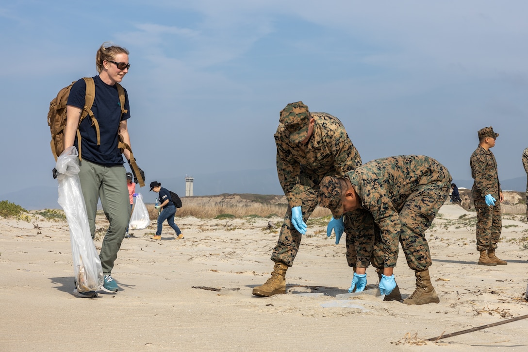 A specialist, left, with the Marine Corps Base Camp Pendleton Environmental Security Department, and U.S. Marines with 3rd Assault Amphibian Battalion, 1st Marine Division, collect trash during a beach cleanup at White Beach at MCB Camp Pendleton, California, Feb. 16, 2024. This cleanup allows MCB Camp Pendleton and its tenant units to conduct preservation efforts while harmonizing environmental efficacy and military readiness. MCB Camp Pendleton takes active steps to preserve regional wildlife and natural resources while providing the Fleet Marine Force with the training spaces necessary to meet training and readiness requirements. (U.S. Marine Corps photo by Lance Cpl.. Watts)