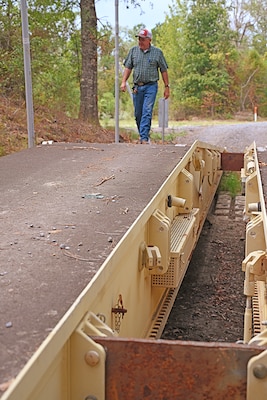 A man walks on a bridge.