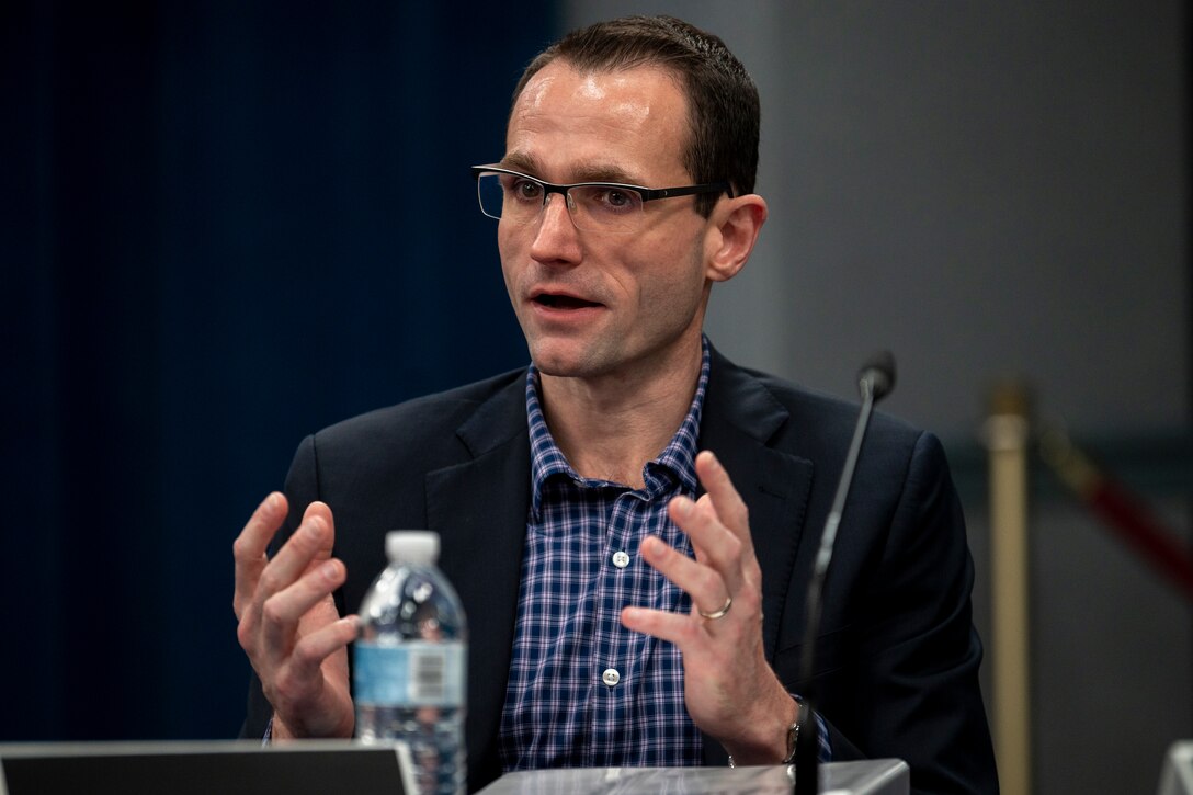 A civilian gestures with his hands.