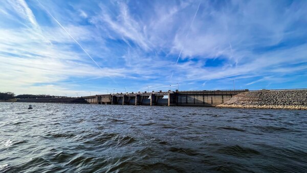 Choppy water with a dam in the far background