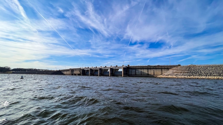 Choppy water with a dam in the far background