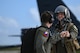 U.S. Air Force Capt. Mark Gerken, pilot assigned to the 23rd Expeditionary Bomb Squadron, fist bumps another crew member as he prepares to board the B-52H Stratofortress at Andersen Air Force Base, Guam, Feb. 3, 2024. The United States maintains a strong, credible bomber force that enhances the security and stability of Allies and partners. (U.S. Air Force photo by Master Sgt. Amy Picard)