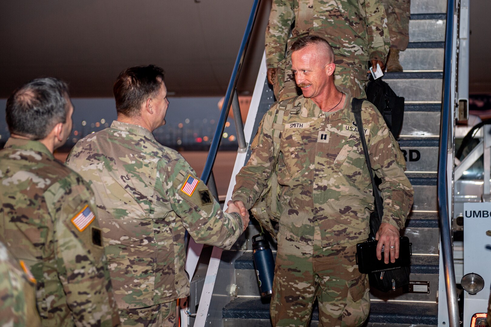 Capt. Jeremiah Smith, a member of Task Force Tomahawk, shakes hands with Col. Andrew Ballenger, commander, 45th Infantry Brigade Combat Team, as Smith arrives at Fort Bliss, Texas, Feb. 18, 2024, following a nine-month deployment to the Horn of Africa. Task Force Tomahawk is made up of units of the 45th Infantry Brigade Combat Team - primarily of the 1st Battalion, 179th Infantry Regiment as well as companies from the 1st Battalion, 279th Infantry Regiment and 2nd Battalion, 134th Infantry Regiment (Airborne). TF Tomahawk was responsible for security at multiple locations across several countries in the Horn of Africa as well as manning the East African Response Force. (Oklahoma National Guard photo by Anthony Jones)