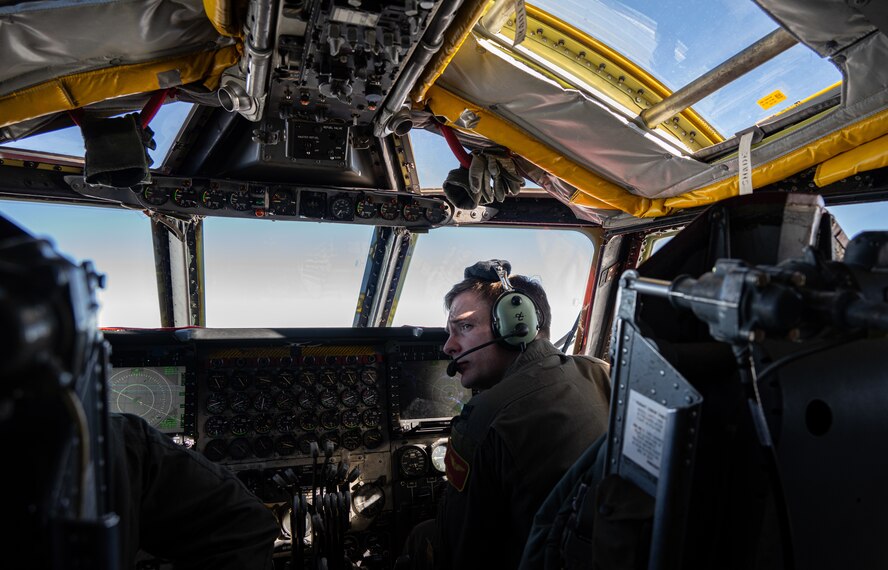 U.S. Air Force Capt. Christian Dahl, 23rd Bomb Squadron aircraft commander, looks out the window as the B-52H Stratofortress flies over the Pacific Ocean, Feb. 12, 2024. The strategic bomber missions offer opportunities for U.S. integration with regional allies and partners, as well as theater familiarization for aircrew members. (U.S. Air Force photo by Airman 1st Class Alyssa Bankston)