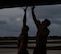 Two B-52H Stratofortress maintenance Airmen jump to close a hatch after receiving a bomber for post-flight inspection at Andersen Air Force Base, Guam, Jan. 30, 2024. Bomber missions familiarize aircrew with air bases and operations in different Geographic Combatant Commands areas of operations. The aircraft and crew are deployed from the 5th Bomb Wing at Minot Air Force Base, North Dakota. (U.S. Air Force photo by Airman 1st Class Alyssa Bankston)