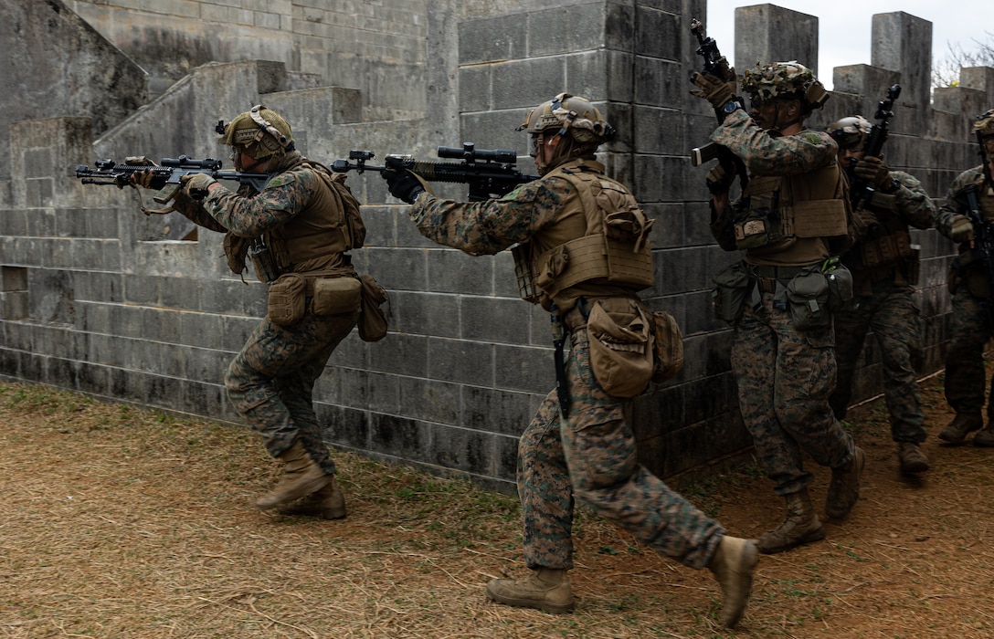 U.S. Marines clear a building during the 3d Marine Division Squad Competition at Camp Hansen, Okinawa, Japan, Jan. 24, 2024. The competition tested the Marines across various combat-related tasks to evaluate each squad’s tactical proficiency, mental and physical endurance, and decision-making skills to determine the Division’s most proficient and capable rifle squad. The Marines are with 3d Littoral Combat Team, 3d Marine Littoral Regiment, 3d Marine Division. (U.S. Marine Corps photo by Cpl. Eduardo Delatorre)