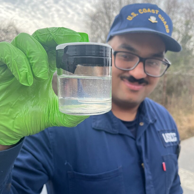 A Coast Guard Sector Charleston Incident Management Division member collects a water sample that contains an oil product found in a storm drain in Charleston, South Carolina, Feb. 12, 2024. Pollution response efforts have concluded with no evidence of additional oil for future potential discharge, recoverable product, or threat to the marine environment. (U.S. Coast Guard courtesy photo)