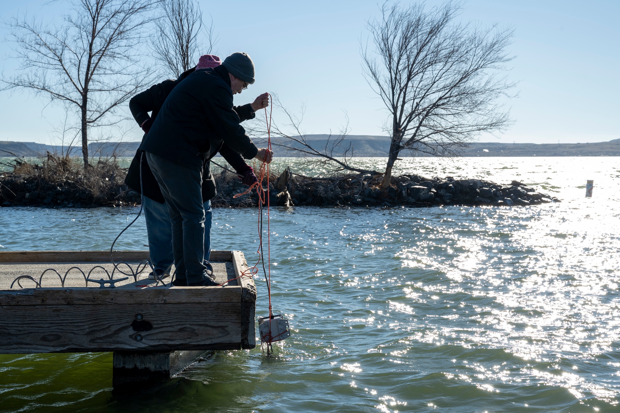 Members of the eLoran Demonstration group pull equipment out of the water after a test.