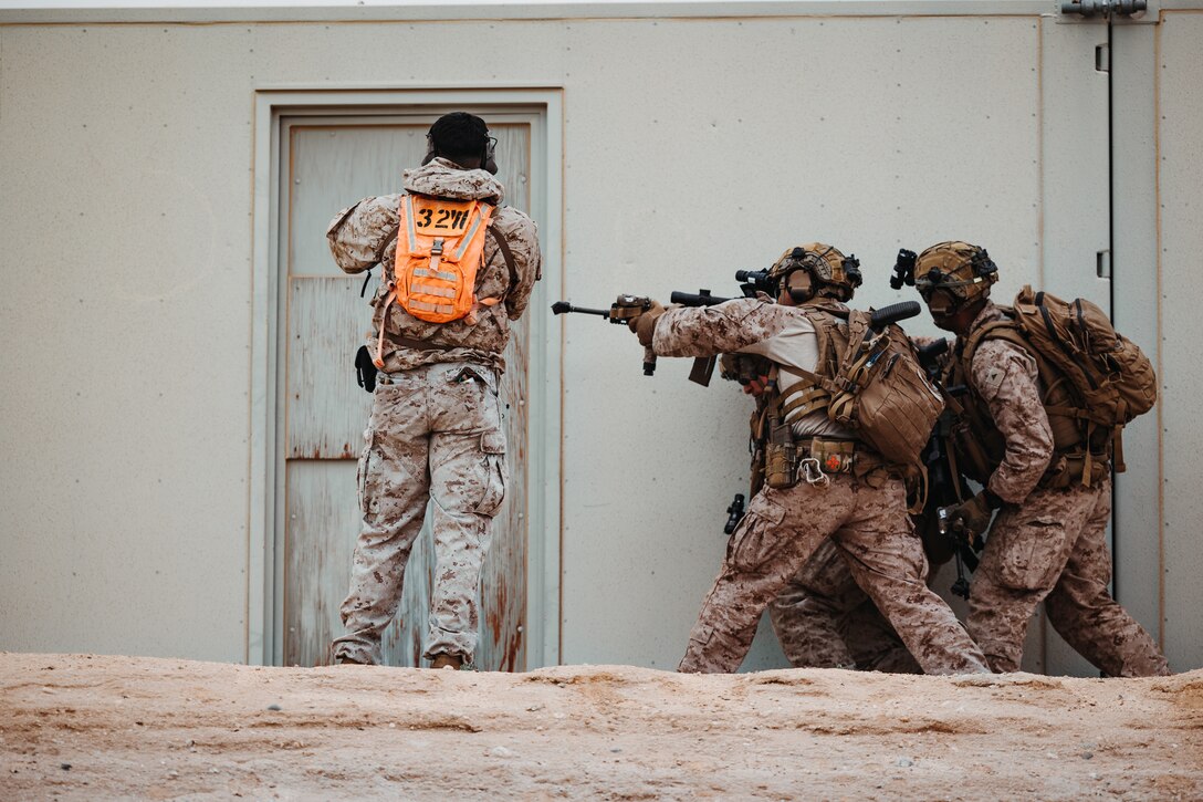 U.S. Marine Corps Sgt. Michael Guzman, a Yuma, Arizona native, service level training instructor with Tactical Training and Exercise Control Group, Marine Air-Ground Task Force Training Command, Marine Corps Air-Ground Combat Center, instructs Marines with the training unit during an Adversary Force Exercise as part of Service Level Training Exercise 2-24 at Range 220, MCAGCC, Twentynine Palms, California, Feb. 1, 2024. The purpose of AFX is to create a credible, realistic threat for the exercise forces participating in SLTE 2-24 to engage against during the upcoming MAGTF Warfighting Exercise in a force-on-force, unscripted wargame. (U.S. Marine Corps photo by Lance Cpl. Richard PerezGarcia)