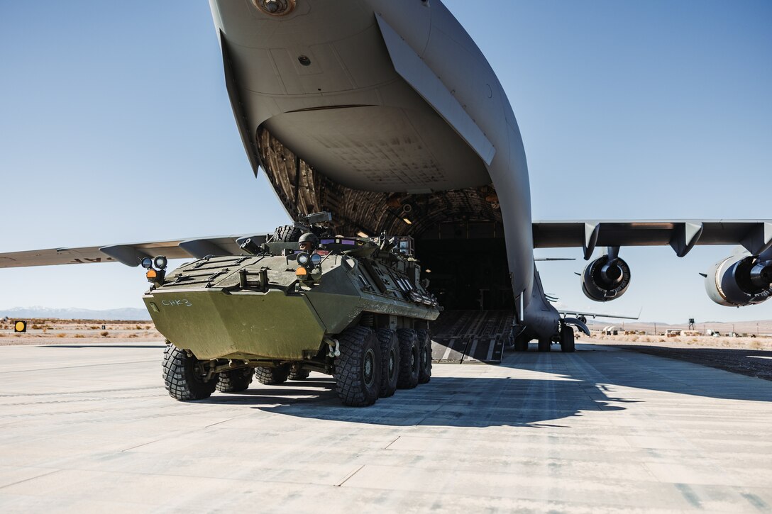U.S. Marines with 3rd Light Armored Reconnaissance Battalion, 1st Marine Division, 1st Marine Expeditionary Force, load Light Armored Vehicles onto a U.S. Air Force C-17 Globemaster III assigned to the 14th Airlift Squadron, 437th Airlift Wing, during a strategic mobility exercise, as part of Service Level Training Exercise 2-24 at Camp Wilson, Marine Corps Air-Ground Combat Center, Twentynine Palms, California, Jan. 25, 2024. Joint interoperability between the Air Force and the U.S. Marine Corps enables Marine units to rapidly embark on C-17’s, allowing the Marine Corps to provide support for expeditionary operations. (U.S. Marine Corps photo by Lance Cpl. Richard PerezGarcia)
