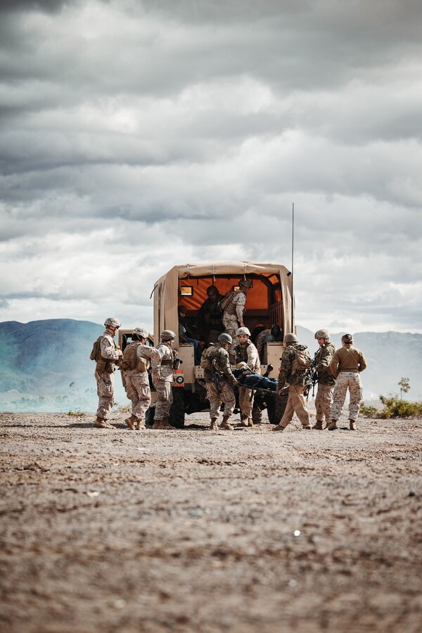 U.S. Marines with Combat Logistics Battalion 11, Headquarters Regiment, 1st Marine Logistics Group, unload a simulated casualty from a Joint Light Tactical Vehicle during an Integrated Training Exercise as part of Service Level Training Exercise 2-24 at Range 111, Marine Corps Air-Ground Combat Center, Twentynine Palms, California, Jan. 23, 2024. The purpose of ITX is to create a challenging, realistic, training environment that produces combat-ready forces capable of operating as an integrated Marine Air-Ground Task Force and to prepare units for their role in the MAGTF Warfighting Exercise. (U.S. Marine Corps photo by Lance Cpl. Richard PerezGarcia)