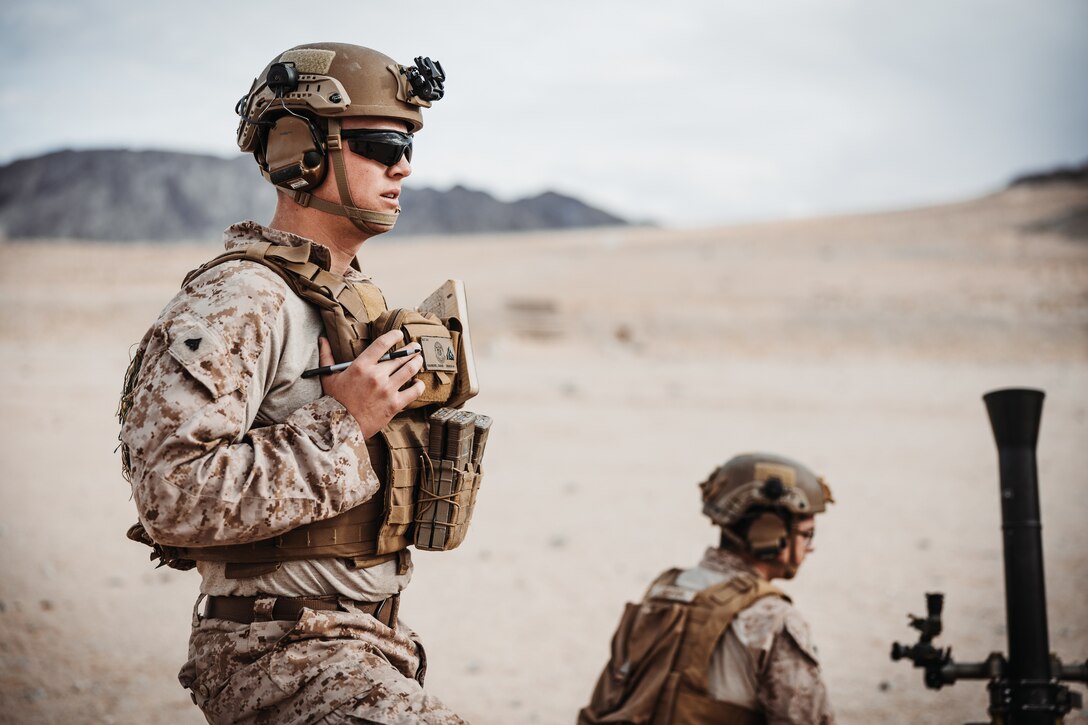 U.S. Marine Corps Cpl. Chase Ramberg, a Sandy, Oregon native, mortarman with 2nd Battalion, 4th Marine Regiment, 1st Marine Division, waits for firing coordinates during an Integrated Training Exercise as part of Service Level Training Exercise 2-24 at Range 106A, Marine Corps Air-Ground Combat Center, Twentynine Palms, California, Jan. 20, 2024. The purpose of ITX is to create a challenging, realistic, training environment that produces combat-ready forces capable of operating as an integrated Marine Air-Ground Task Force and to prepare units for their role in the MAGTF Warfighting Exercise. (U.S. Marine Corps photo by Lance Cpl. Richard PerezGarcia)