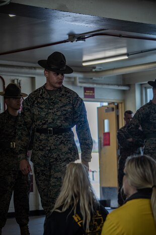 U.S. Marine Corps Staff Sgt. Marcus Harris, a drill instructor with Alpha Company, 1st Recruit Training Battalion, Recruit Training Regiment, conducts a mock senior drill instructor speech for spouses taking part in the "In Their Boots" event at Marine Corps Recruit Depot San Diego, Feb. 16, 2024. In Their Boots is designed to inform Marine Corps spouses about the duties of their significant others and give them a peek into the rigors of recruit training. (U.S. Marine Corps photo by Sgt. Jesse K. Carter-Powell)