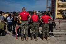 U.S. Marine Corps Sgt. Payton Bauserman (left), Sgt. Harry Le (center), and Melvin Melendezgarcia (right), all Drill Instructors with 1st Recruit Training Battalion, Recruit Training Regiment, hand out gear for the rappel tower to the spouses taking part in the "In Their Boots" event at Marine Corps Recruit Depot San Diego, Feb. 16, 2024. In Their Boots is designed to inform Marine Corps spouses about the duties of their significant others and give them a peek into the rigors of recruit training. (U.S. Marine Corps photo by Sgt. Jesse K. Carter-Powell)