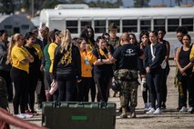 U.S. Marine Corps spouses taking part in the "In Their Boots" event receive a safety brief prior to taking on the rappel tower at Marine Corps Recruit Depot San Diego, Feb. 16, 2024. In Their Boots is designed to inform Marine Corps spouses about the duties of their significant others and give them a peek into the rigors of recruit training. (U.S. Marine Corps photo by Sgt. Jesse K. Carter-Powell)
