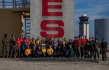 U.S. Marines and spouses taking part in the "In Their Boots" event pose for a photo at Marine Corps Recruit Depot San Diego, Feb. 16, 2024. In Their Boots is designed to inform Marine Corps spouses about the duties of their significant others and give them a peek into the rigors of recruit training. (U.S. Marine Corps photo by Sgt. Jesse K. Carter-Powell)