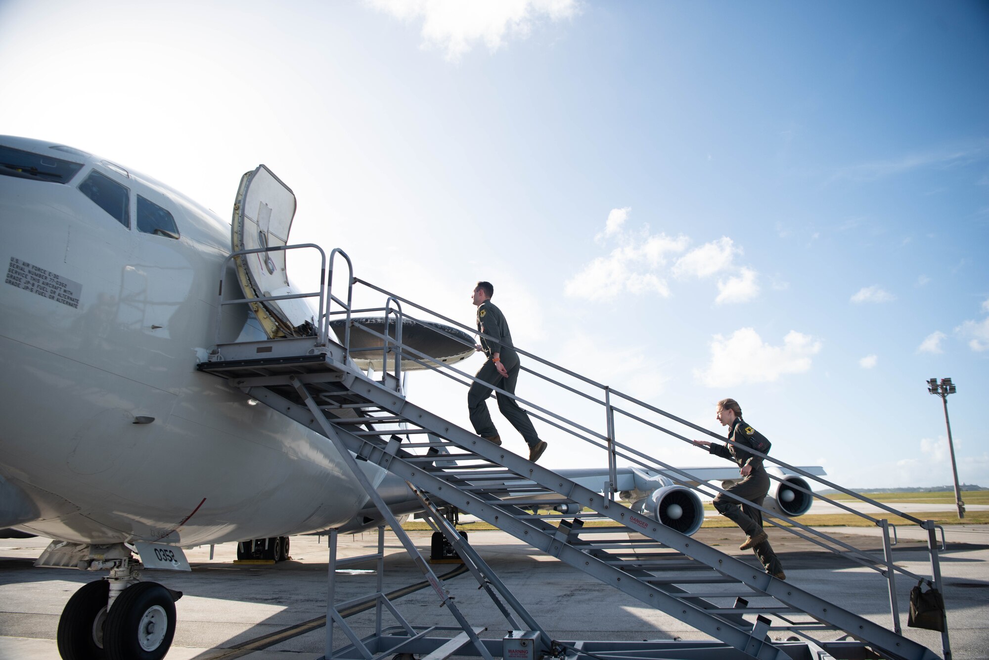 Airmen board an aircraft.
