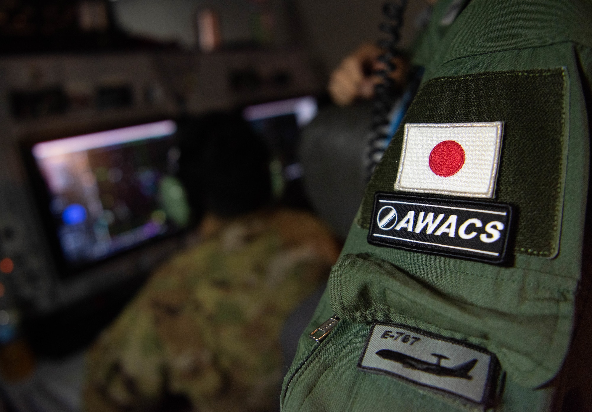 A Japan flag and AWACS patch on a JASDF Airman.