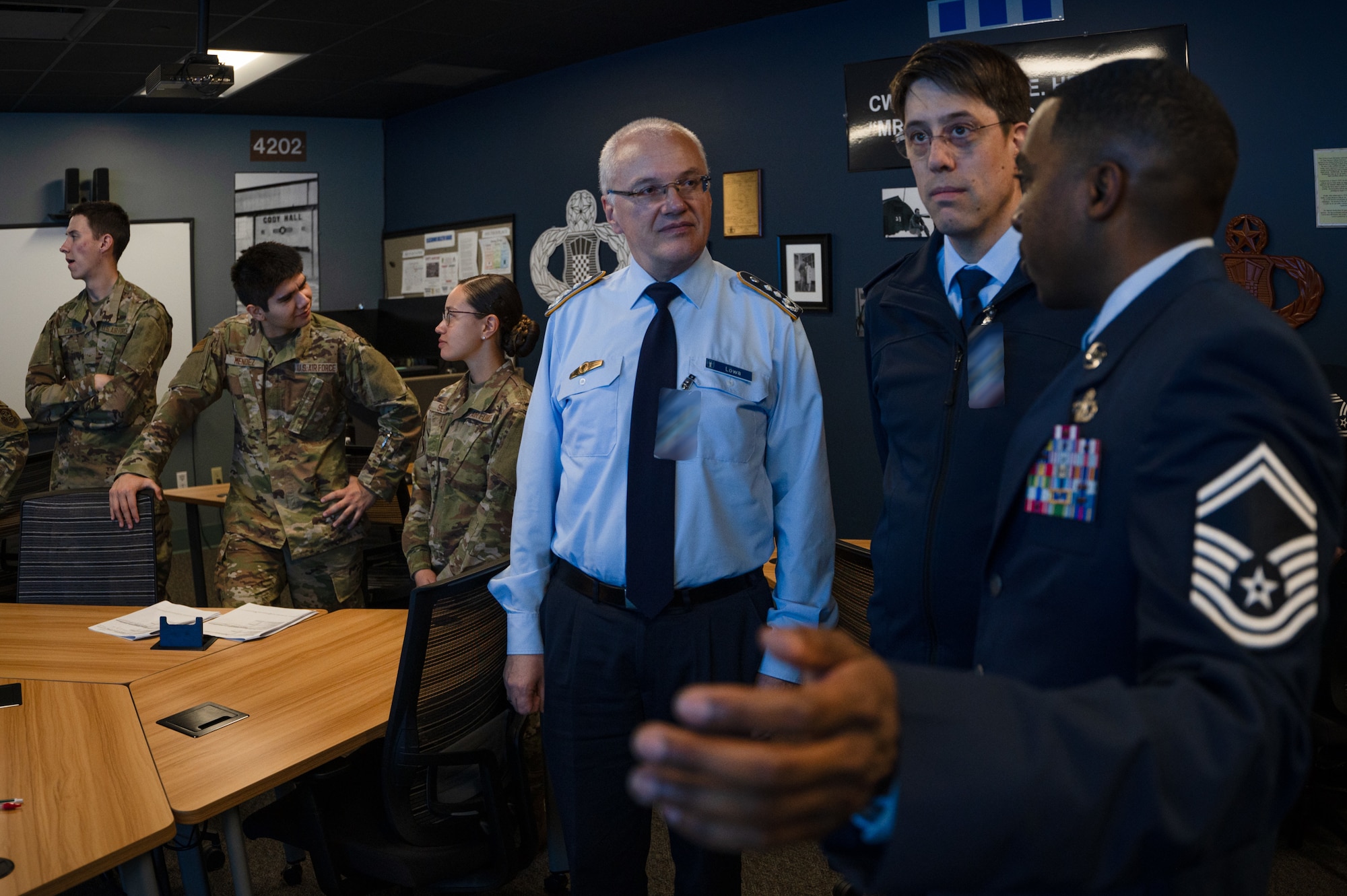 U.S. Air Force Senior Master Sgt. Andre Heags, 334th Training Squadron air traffic control training superintendent, briefs members from the German Military Aviation Authority on how the MaxSim Tower Simulator is utilized on Keesler Air Force Base, Mississippi, Feb. 12, 2024.
